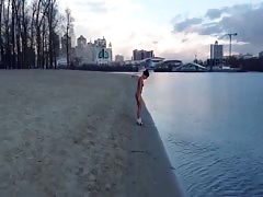 Hot busty babe is walking fully naked by the river!