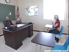 Blonde is kneeling down in front her teacher and starting to suck